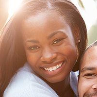 A man and a woman are smiling for the camera.